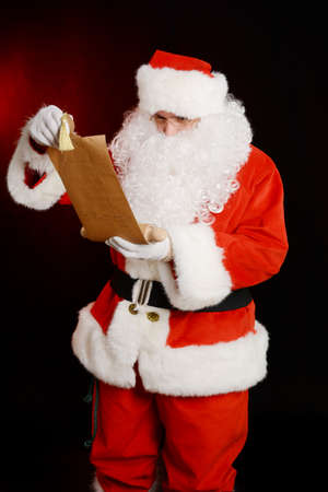 Santa Claus holding scroll of parchment,Santa Claus holding his naughty and nice listの写真素材