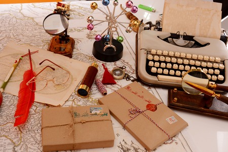 Table in Santa Claus's office. Typewriter, glasses, letters, packages, spyglass, magnifier