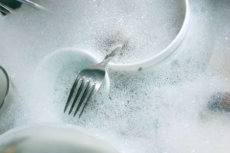 Washing kitchen ware on the sinkの写真素材