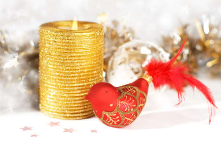 Christmas background with gold candle and decorative birdの写真素材