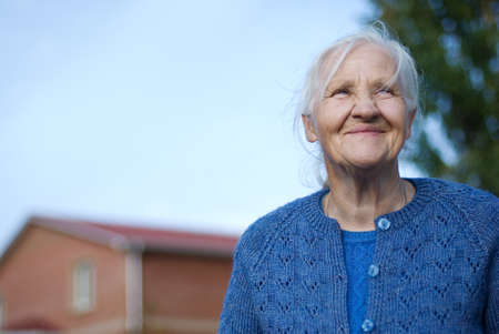 Happy elderly woman, building on the background の写真素材