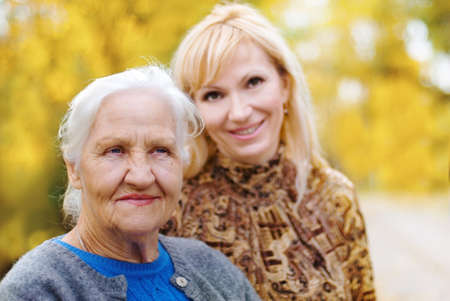 Elderly woman with daughter in a gardenの写真素材