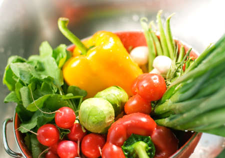 Fresh washed vegetables in colander