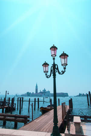 Pier for gondolas  in the Grand Canal, in Venice, in front of San Giorgio Maggiore church, Italyの写真素材