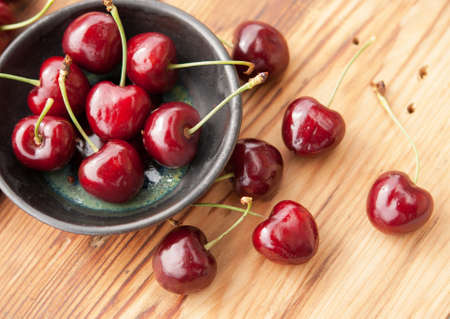 Sweet fresh cherries in a ceramic bowlの写真素材
