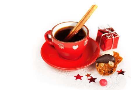 Hot winter coffee with cinnamon sticks, cookies and christmas giftの写真素材