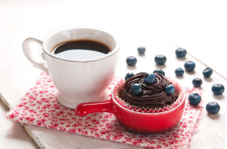Morning coffee, cupcake with chocolate and blueberry on a table, Blueberry Chocolate Muffinの写真素材