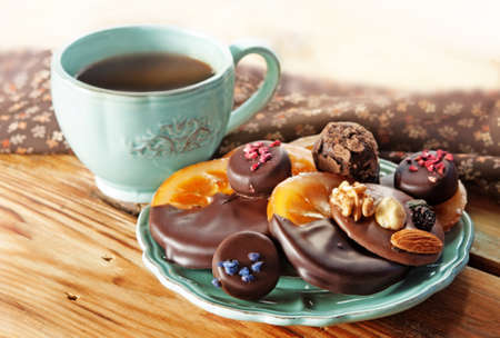 Cup of coffee, Assortment of fine chocolates dark, and milk chocolate, orange in chocolate and...