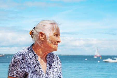 Portrait of happy eldery woman on the seasideの写真素材