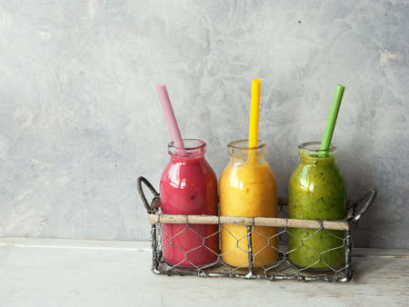 Three fresh blended Fruit Smoothies in jarの写真素材