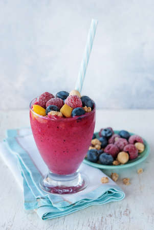 Berry smoothie with  almond milk, granola muesly and nuts - healthy breakfast. Selective focusの写真素材