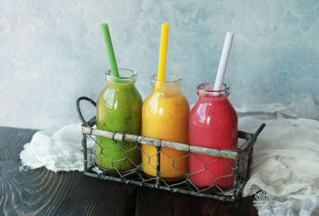 Three fresh blended Fruit Smoothies in jarの写真素材