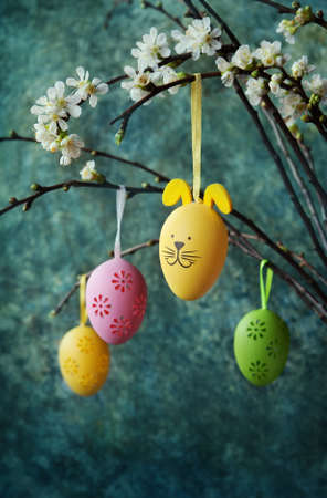 Easter colorful eggs hanging at a blooming branchの写真素材