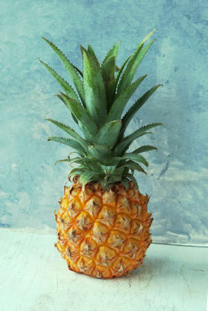 Fresh Pineapple on a rustic blue and white backgroundの写真素材