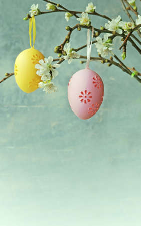 Easter colorful eggs hanging at a blooming branchの写真素材