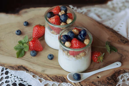 Healthy breakfast, fresh blueberry, strawberry, nuts, granola and yogurtの写真素材