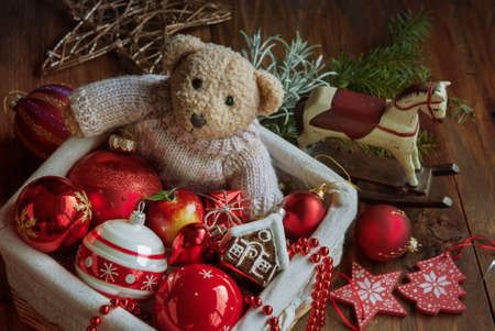 Christmas decor balls with bear toy, wooden horse in the boxの写真素材
