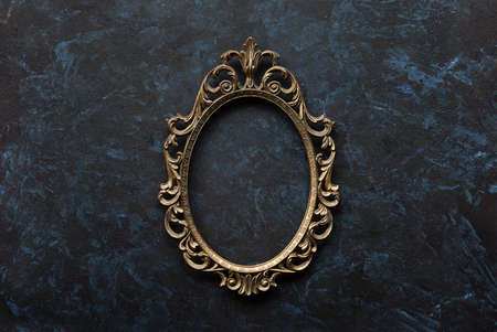 Openwork metal oval frame on a dark background