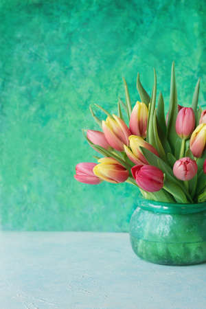 Beautiful spring flowers tulips in glass vase, Vertical formatの写真素材