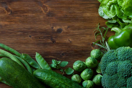 Green vegetales on a wood backgroundの写真素材