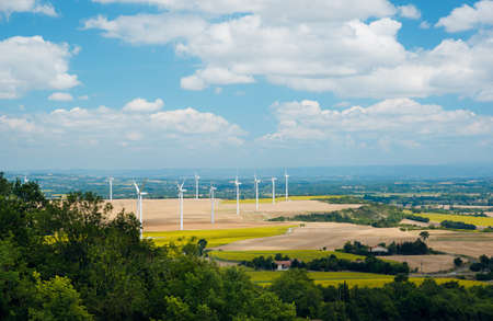 Wind turbines in France. Fields with windmills. Field in bloom. Renewable energy. Protect the environment.の写真素材