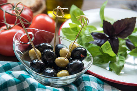Italian food: basil, tomatoes, olive on table. Selective focusの写真素材