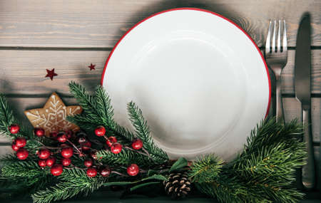 Christmas dinner background, plate on rustic wooden table, top view
