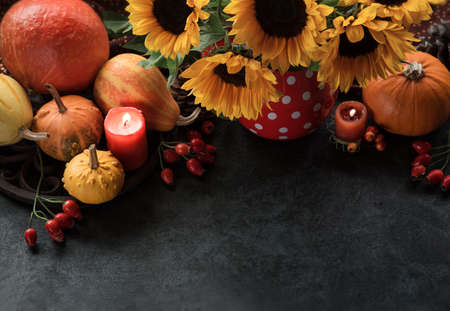 Thanksgiving background with pumpkins, candles and sunflowers, Autumn decorの写真素材