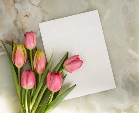Greeting card, bouquet of beautiful flowers, spring tulips on a marble background