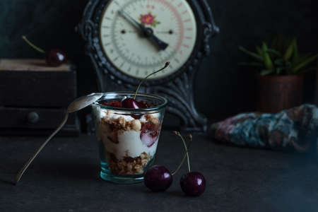 Homemade granola with bio yogurt and fresh cherries