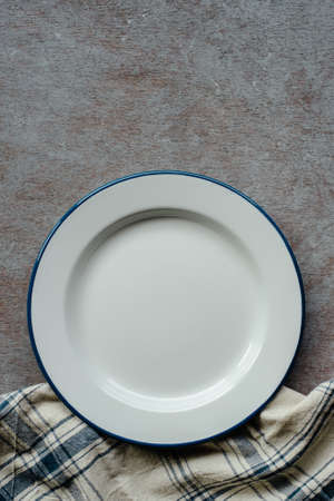 Dinner background, plate and napkin on rustic table, top view with place for textの写真素材
