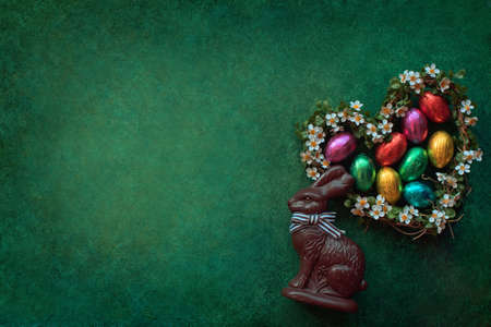 Easter background with chocolate rabbit and eggsの写真素材