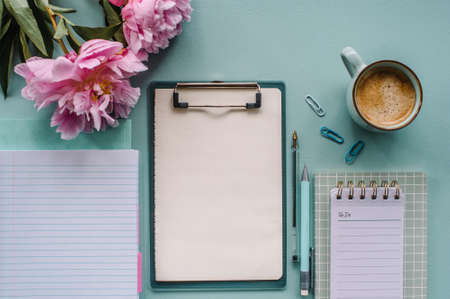 To do list with planning top view, office papers with cup of coffe and flowers