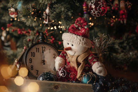 Christmas card with decorations and snowman at home near christmas tree. Place for textの写真素材