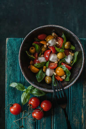 Tasty caprese salad with ripe red tomatoes, mozzarella, and basil. Italian food. Top viewの写真素材