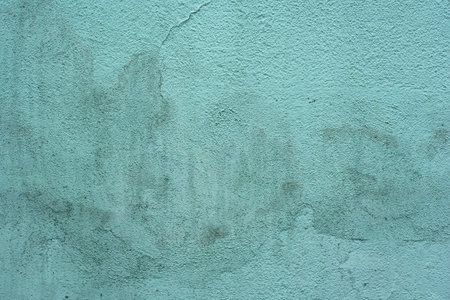 Blue mint color grunge cement wall, old textured background with drips and cracksの写真素材