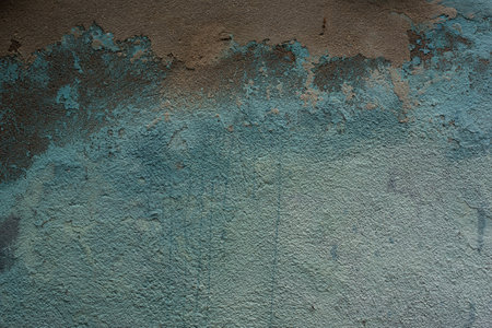 Blue painted wall with sprinkled clay putty old textured background with drips and cracksの写真素材