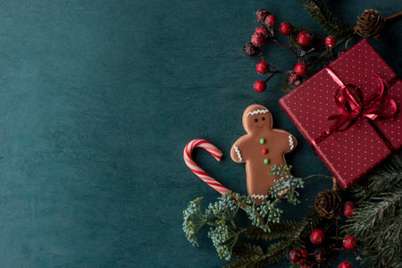 Christmas gift, decorations and gingerbread men cookies on wood background. Flat lay image with space for textの写真素材