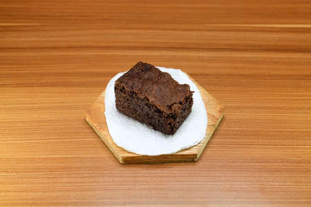 Chocolate brownie cake slices served on a wood with a wooden background.の写真素材