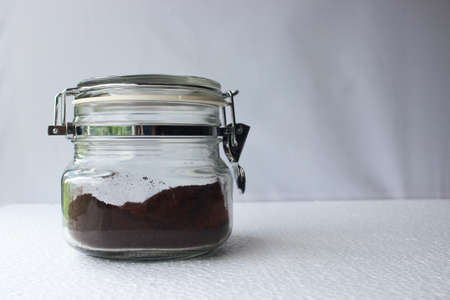 Jar of ground instant coffee on white background.の写真素材