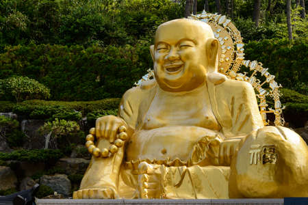 Smiling Buddha statue at Haedong Yonggungsa Temple, Busan, South Koreaの写真素材