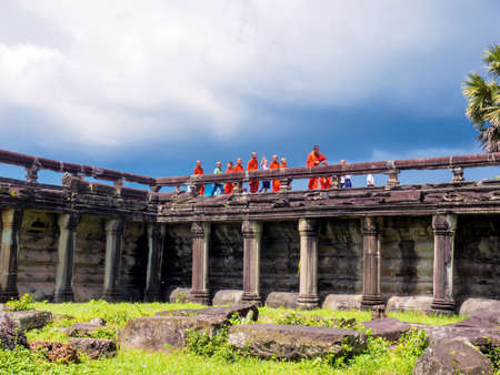 Siem Reap, Cambodia - October 30, 2016: Buddhist monks and novices walking on the stone bridge to enter Angkor Watのeditorial素材