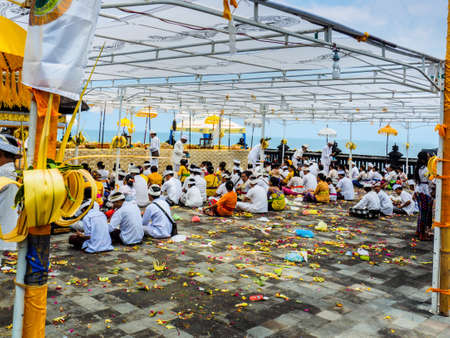 Bali, Indonesia - September 17, 2016: Balinese worshippers gathering at Tanah Lot Temple for the Galungan festival celebrating the return of Balinese gods and deified ancestors to Bali.のeditorial素材