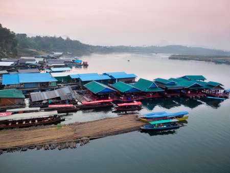 Sangkhlaburi - March 05, 2017: The scenery of  floating village and a part of temporary bamboo bridge  the river in Sangkhlaburi District, Thailand, in the early morning.のeditorial素材
