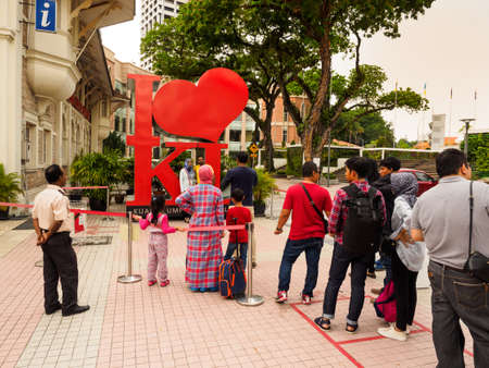 Kuala Lumpur, Malaysia -  April 22, 2017: Tourists queuing up for posing with theのeditorial素材