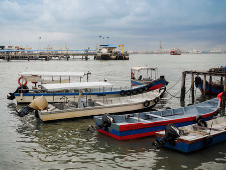 Penang,  Malaysia - April 24, 2017: Motorized Boats boat docking at Clan Jetty  or water villages  which are homes to various Chinese clan in George town, Penang, Malaysia.のeditorial素材