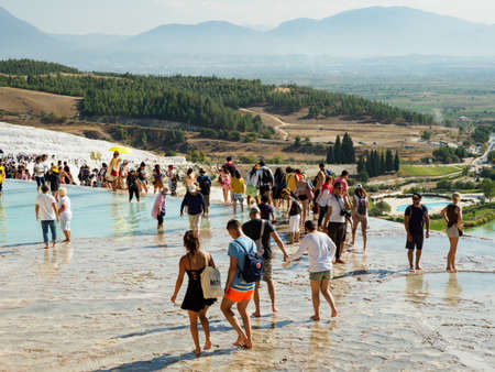 Pamukkale, Turkey - October 07, 2018: Tourists visiting the Pamukkale travertines or Cotton Castle in Denizli Province, Turkey.のeditorial素材