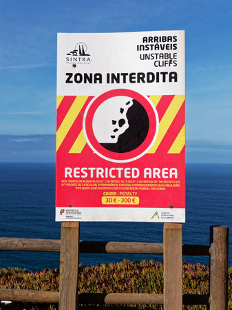 Cabo da Roca, Portugal - October 02, 2019: The signboard of  danger zone and restricted area at Cabo da Roca or the Cape Roca which is the westernmost point of Europe.のeditorial素材