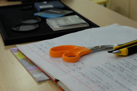 scissors, pen, wallet and notebook on the table in the office