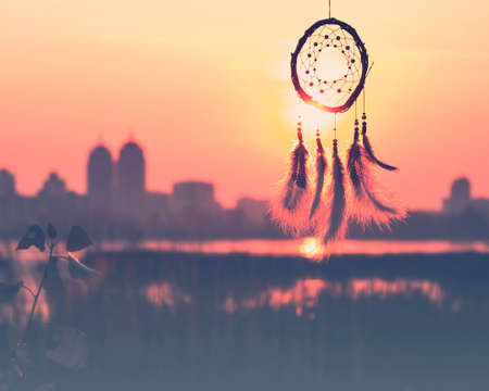 Dream catcher against the sky. City across the river. Far from the bustle of the city. Horizontal photography.の写真素材